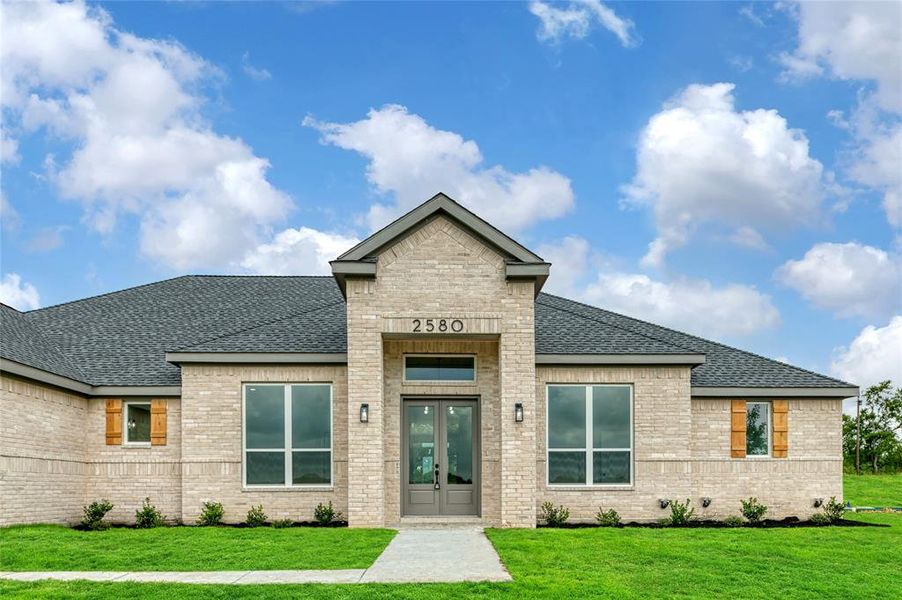 Rear view of property with a lawn