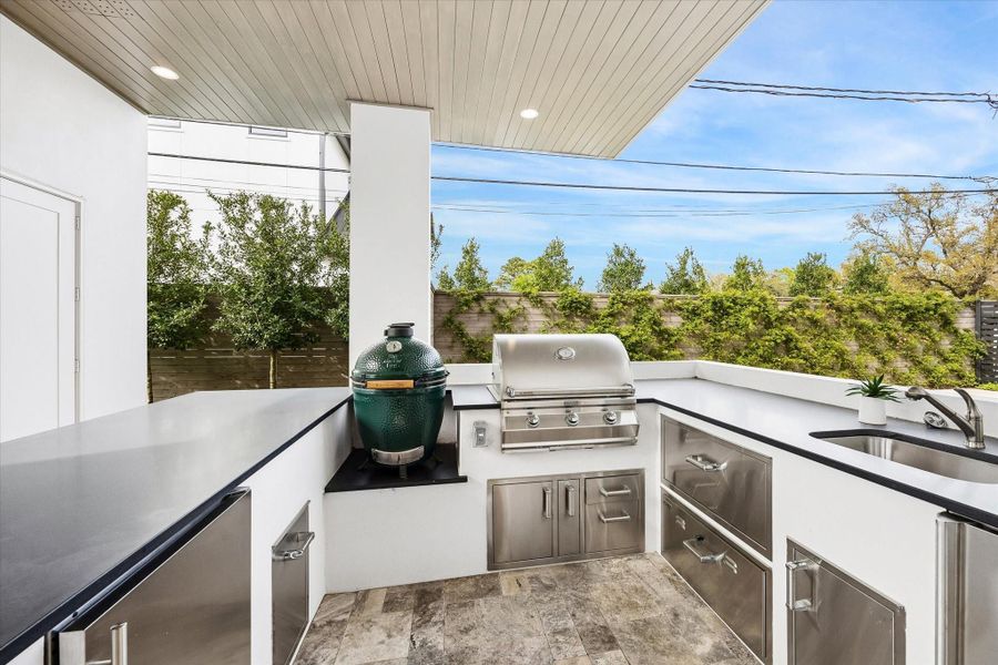 Outdoor grill area has everything you could possibly need. A big green egg, ice machine, refrigerator, and a 36 inch gas grill. There are also warming drawers and a built in trash can. Outdoor grill area has everything you could possibly need. A big green egg, ice machine, refrigerator, and a 36 inch gas grill. There are also warming drawers and a built in trash can.