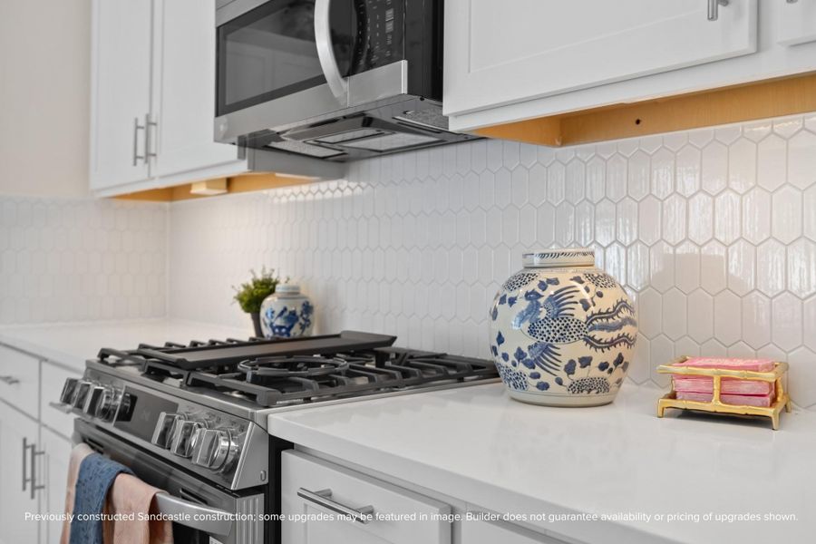 A chef-worthy setup with style to match. Sleek appliances and a striking backsplash bring form and function to the forefront.