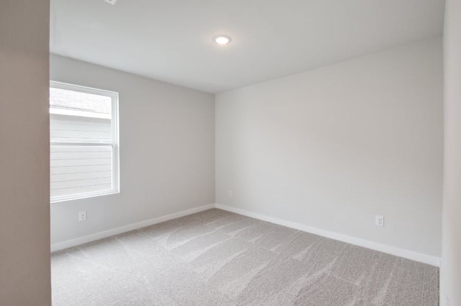 A room with a carpet and a window. A room with a carpet and a window.