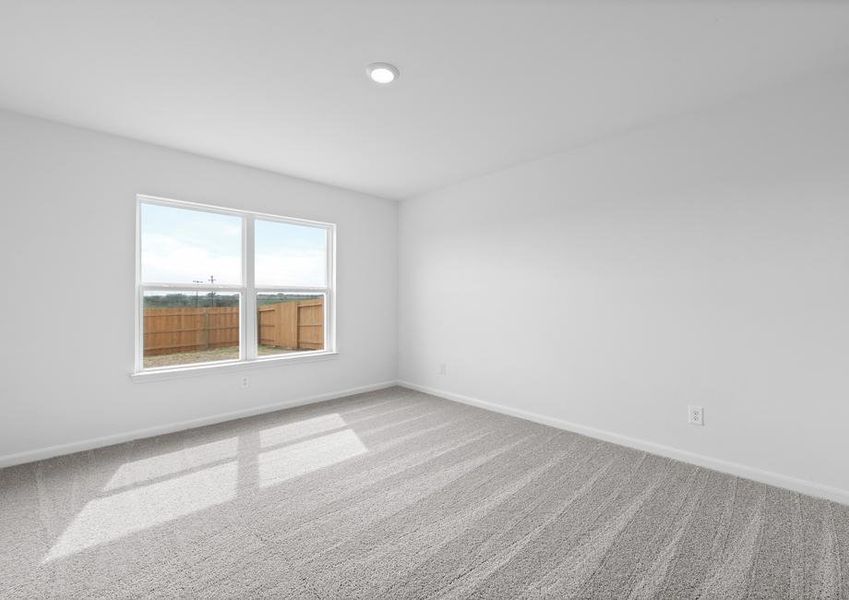 The master bedroom has a large window that allows for natural light