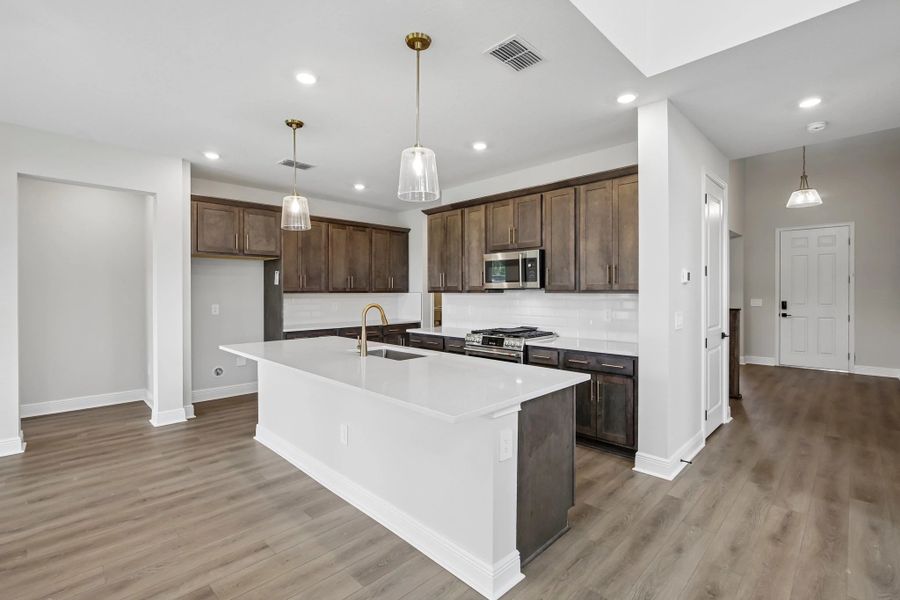 Spacious kitchen with a large island and plenty of cabinet space features AW Collection® Oxford