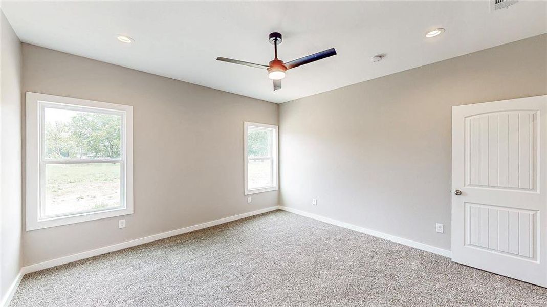 Primary suite is separate from the other bedrooms and has great views of the backyard