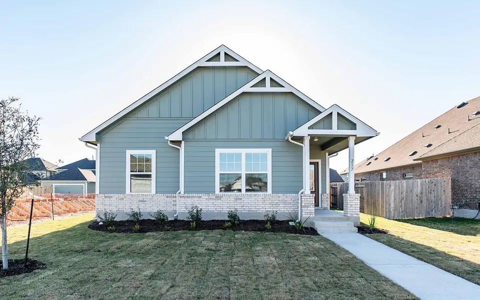 Front exterior of a new home in Paramount, Kyle, TX, highlighting curb appeal (Image 1). Front exterior of a new home in Paramount, Kyle, TX, highlighting curb appeal (Image 1).
