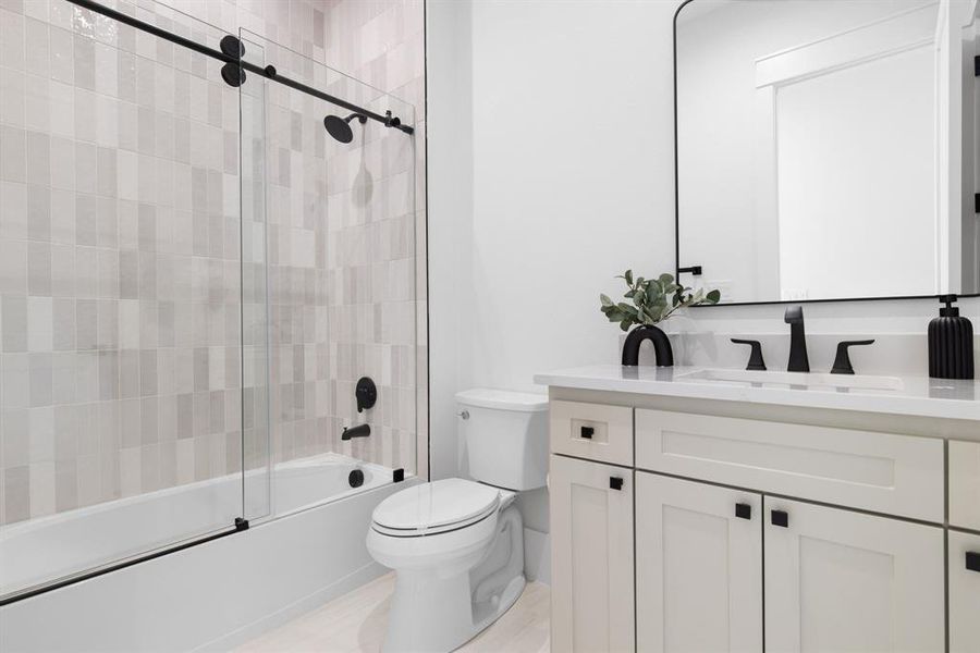 Full bathroom featuring vanity, toilet, and combined bath / shower with glass door