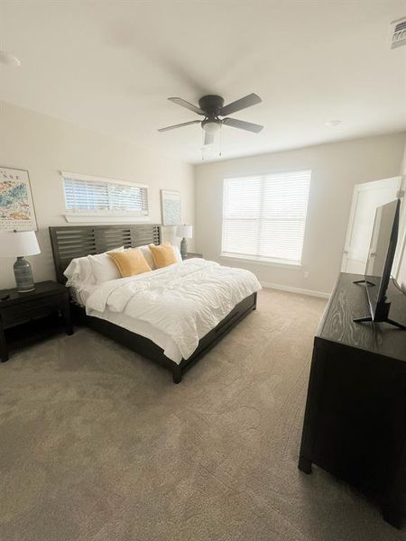 Bedroom with ceiling fan and carpet flooring