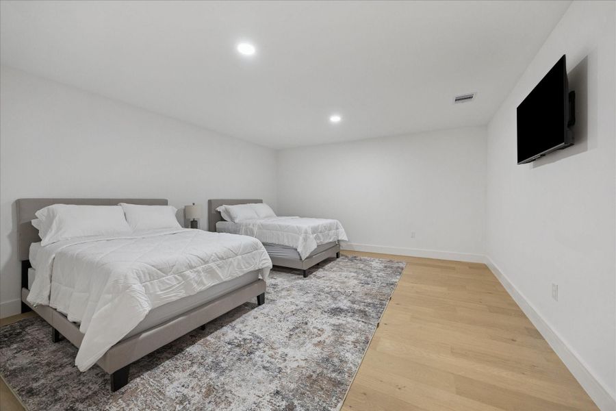 Versatile fourth-floor flex space with recessed lighting and ample room for a game room, media lounge, or optional fourth bedroom.