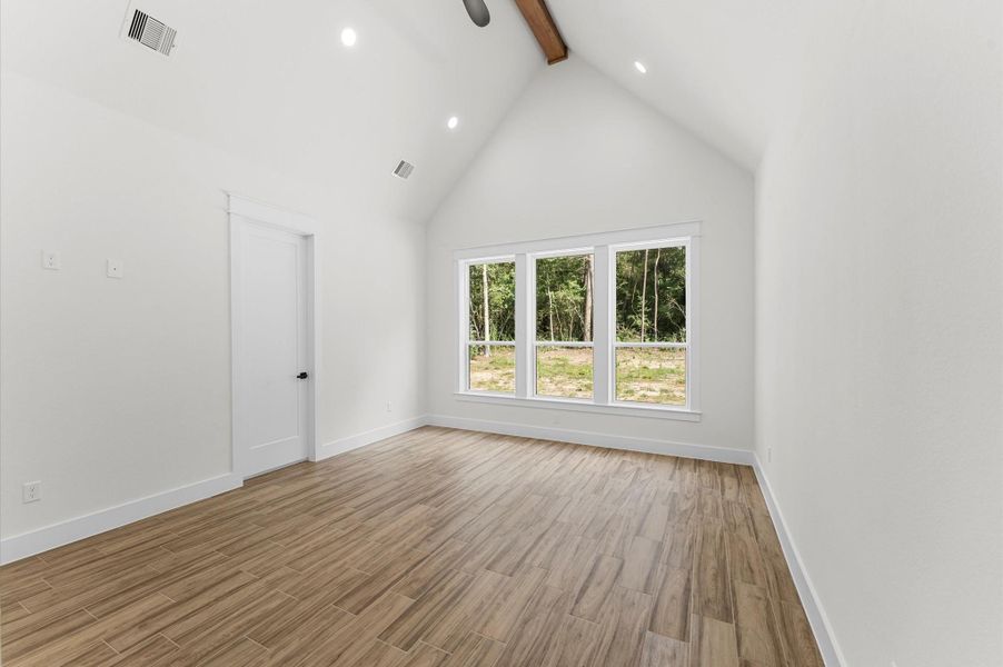 Retreat-style primary suite with cathedral ceiling, expansive windows, and space to relax in comfort. Retreat-style primary suite with cathedral ceiling, expansive windows, and space to relax in comfort.