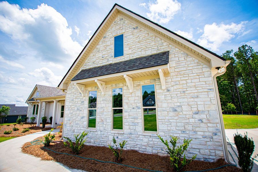 Front exterior of a new home in WOODMONT RESERVE, Roopville, GA, highlighting curb appeal (Image 30).