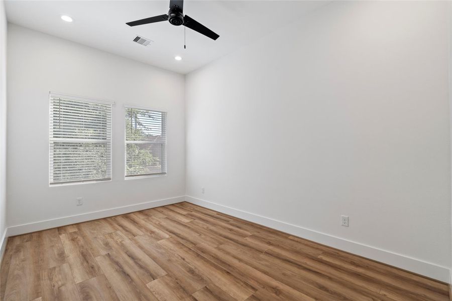 Each secondary bedroom features durable and stylish luxury vinyl plank flooring, combining comfort and easy maintenance throughout the home’s private retreats