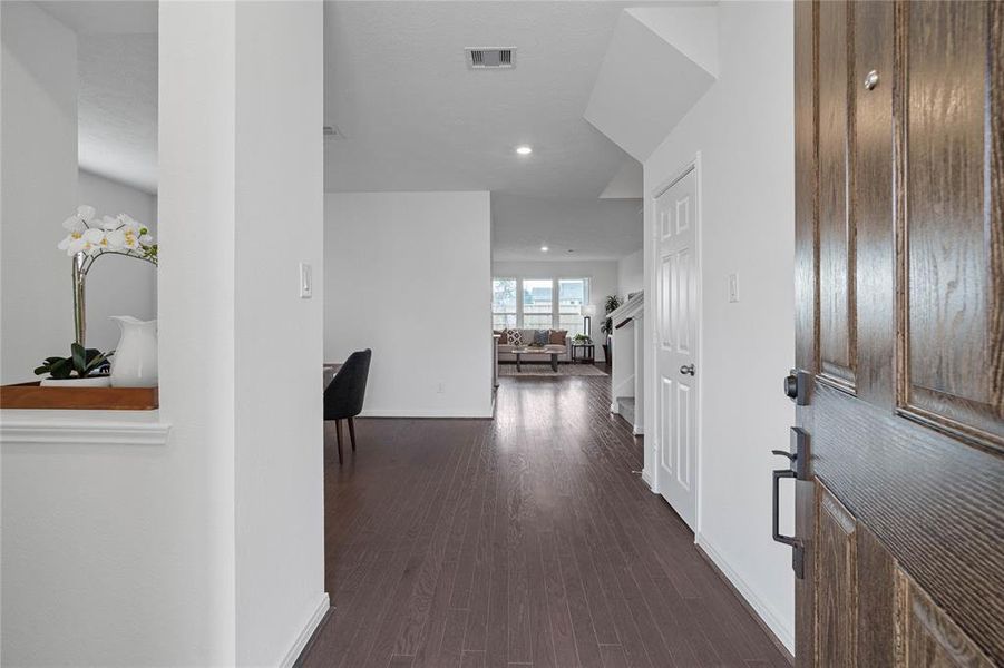 Welcome to your new home at 3527 Sage Green. You are greeted with this beautiful entryway featuring engineered wood flooring, neutral paint, and recessed lighting.