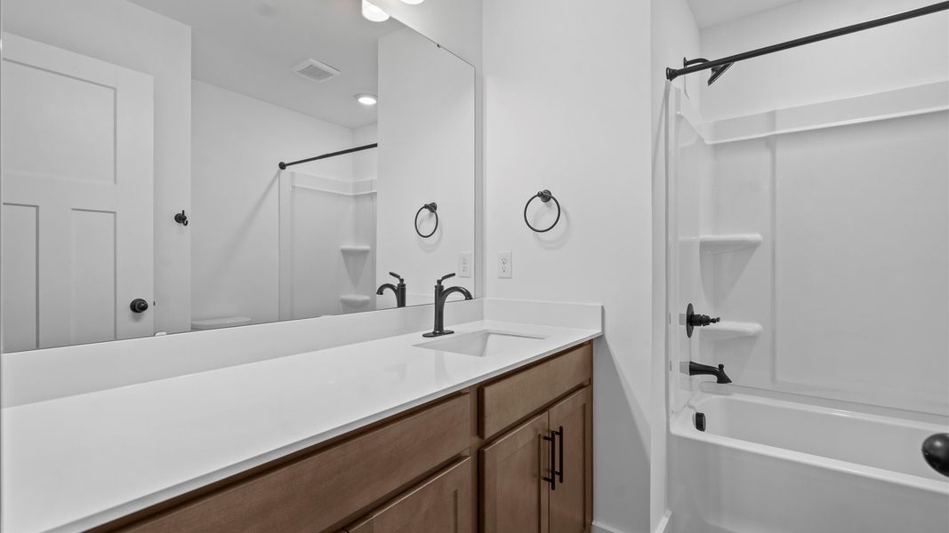 First-rate full bath featuring modern surfaces and a fresh, current color palette First-rate full bath featuring modern surfaces and a fresh, current color palette