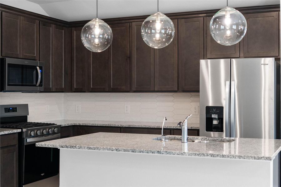 This gorgeous kitchen is an entertainer’s dream, featuring an oversized island, premium finishes, and abundant storage. Designed as the home's ultimate social hub, it offers the perfect balance of open-concept beauty and functional workspace.