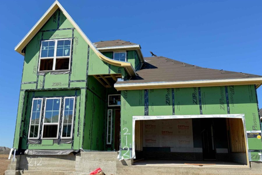 Property under construction featuring a garage and stucco siding