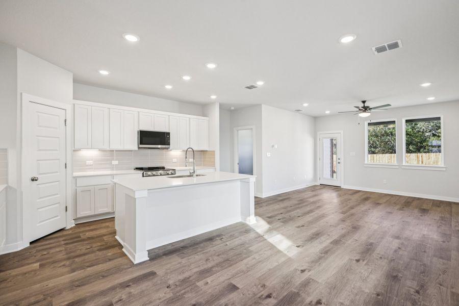 A kitchen with white cabinets.