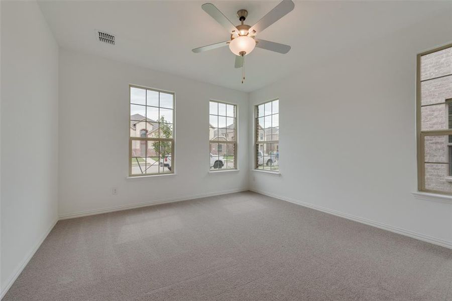 Spare room with carpet flooring and ceiling fan