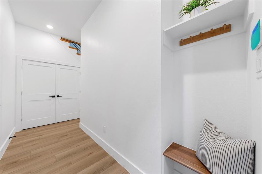 Mudroom featuring light wood-style flooring and baseboards Mudroom featuring light wood-style flooring and baseboards