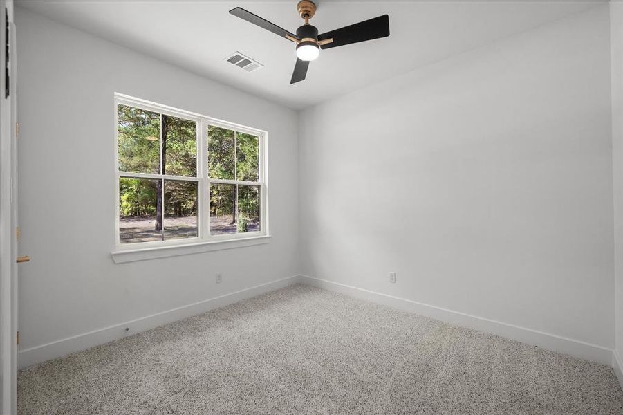 Unfurnished room featuring carpet flooring and a ceiling fan