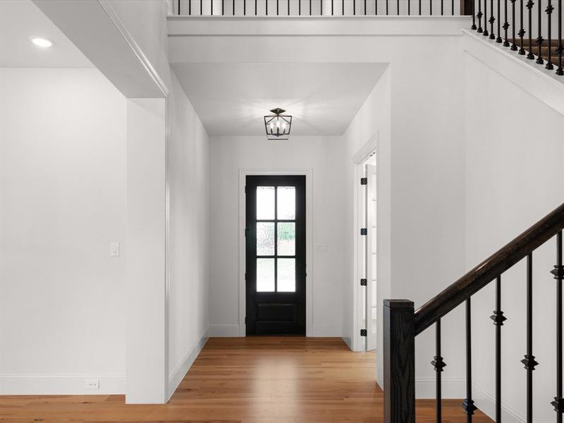Entrance foyer with stairs, wood finished floors, and recessed lighting
