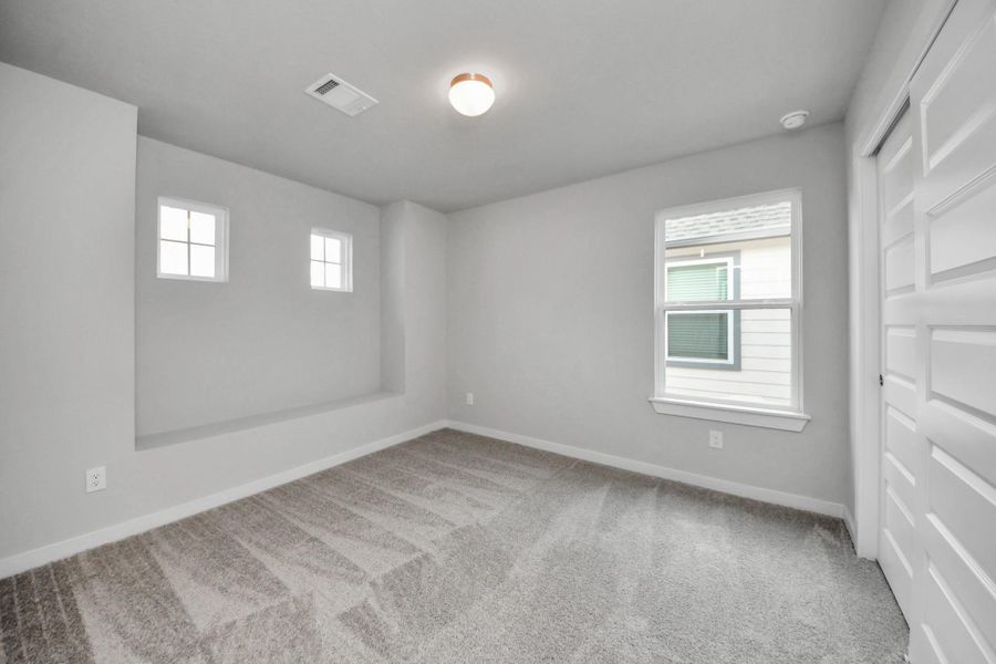Secondary bedroom features plush carpeting, large windows that let in plenty of natural light, bright paint, and spacious closets. Secondary bedroom features plush carpeting, large windows that let in plenty of natural light, bright paint, and spacious closets.