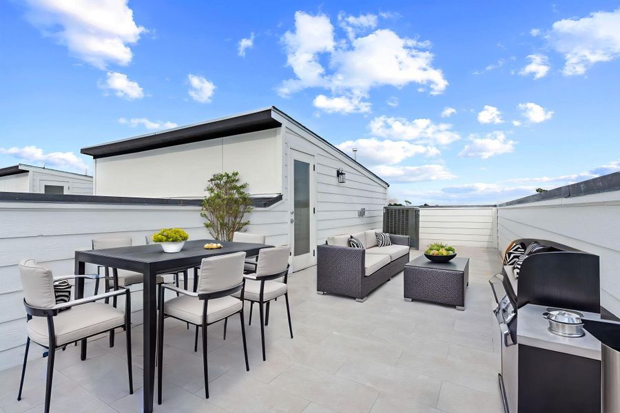 Virtually staged to showcase warm twilight gatherings, this rooftop terrace invites you to unwind, cook under the stars, and connect with friends in a stylish, open-air setting.