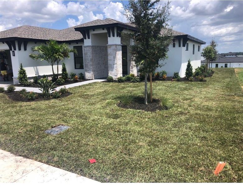 Front exterior of a new home in , Lake Alfred, FL, highlighting curb appeal (Image 13). Front exterior of a new home in , Lake Alfred, FL, highlighting curb appeal (Image 13).