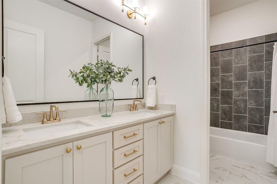 Bathroom featuring double vanity and large mirror. Bathroom featuring double vanity and large mirror.