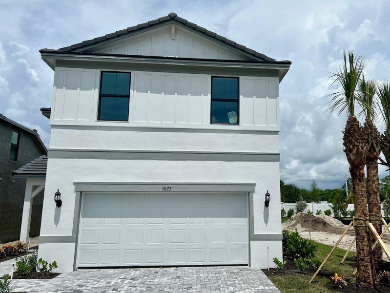Front exterior of a new home in Hendrix Reserve, Lake Worth, FL, highlighting curb appeal (Image 2). Front exterior of a new home in Hendrix Reserve, Lake Worth, FL, highlighting curb appeal (Image 2).