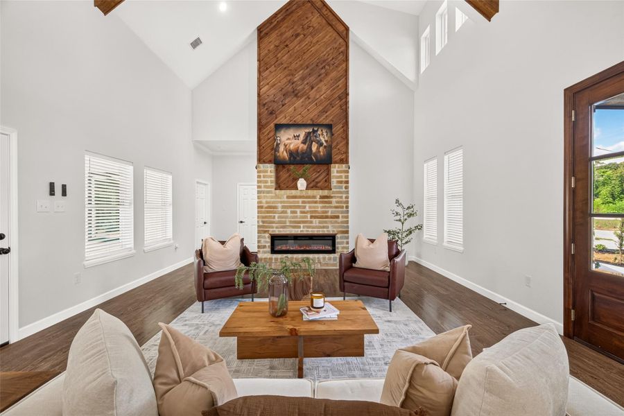 Dramatic living room featuring soaring 22-foot cathedral ceilings and an expansive open-concept design.