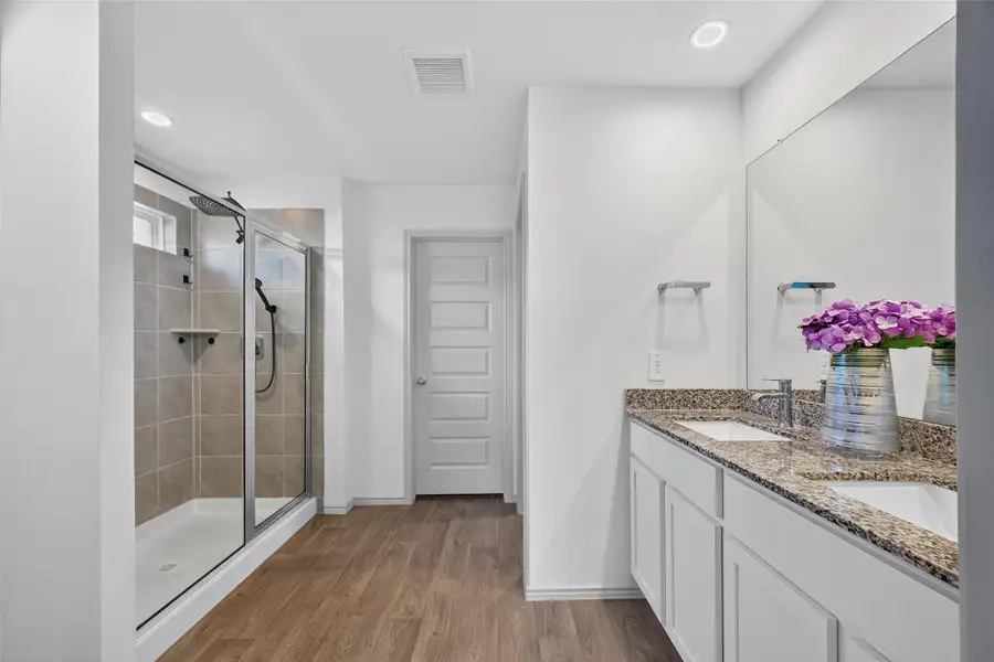A spacious bathroom featuring double sinks and a walk-in shower—perfect for busy mornings and everyday convenience. A spacious bathroom featuring double sinks and a walk-in shower—perfect for busy mornings and everyday convenience.