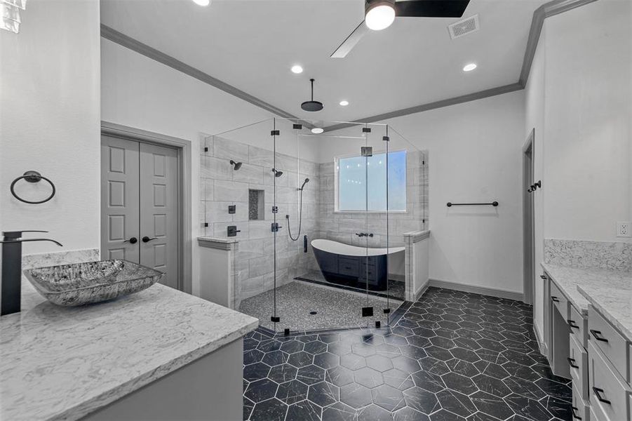 Bathroom featuring ceiling fan, vanity, shower with separate bathtub, and ornamental molding