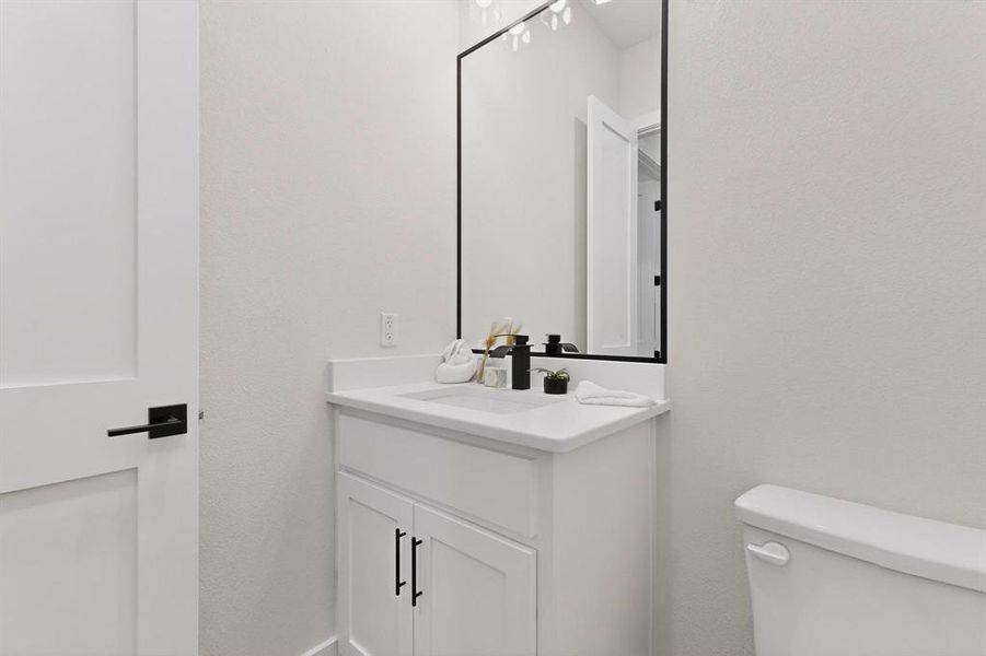 Bathroom featuring vanity and a textured wall