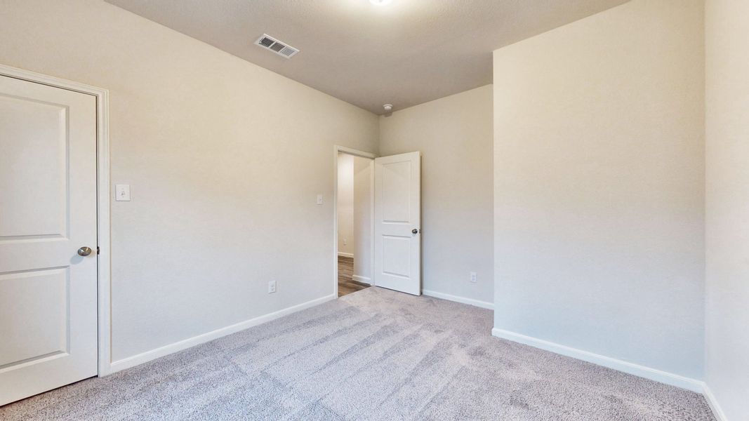 A hallway with white doors.