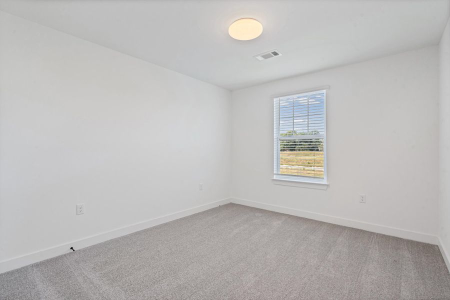Neutral wall paint, light-colored carpeting, single window with blinds, and flush-mount ceiling light Neutral wall paint, light-colored carpeting, single window with blinds, and flush-mount ceiling light