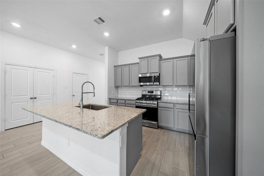 The fully updated kitchen is designed with modern finishes, featuring sleek countertops, high-end appliances, and ample storage, making it both stylish and functional.