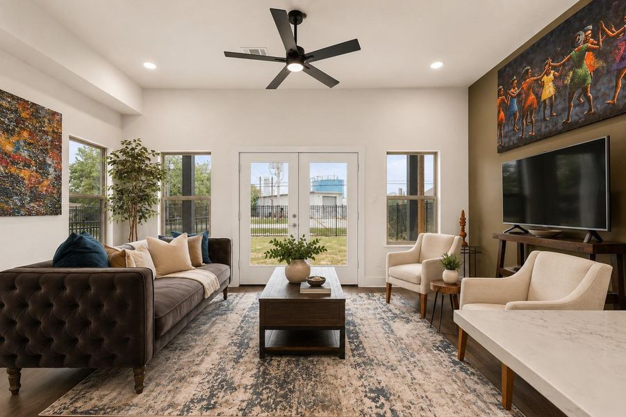 Open-concept living designed for connection, featuring elevated ceilings, abundant natural light, and seamless flow into the kitchen and dining spaces.