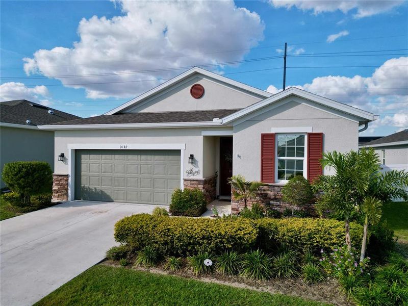 Front exterior of a new home in Seasons at Heritage Square, Haines City, FL, highlighting curb appeal (Image 20). Front exterior of a new home in Seasons at Heritage Square, Haines City, FL, highlighting curb appeal (Image 20).