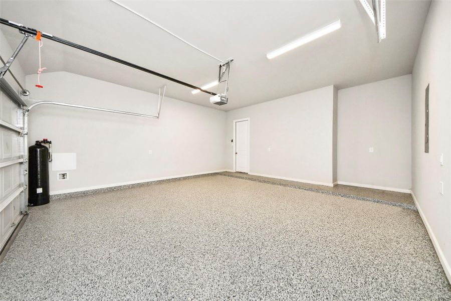 Spacious garage with professionally finished epoxy-coated flooring, enhancing both appearance and long-term durability.