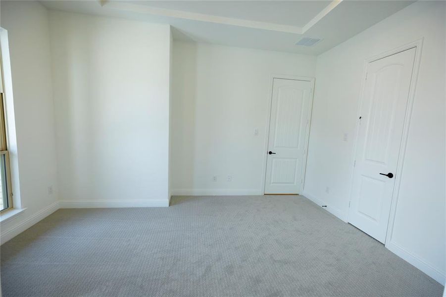 Unfurnished bedroom featuring carpet flooring and baseboards Unfurnished bedroom featuring carpet flooring and baseboards