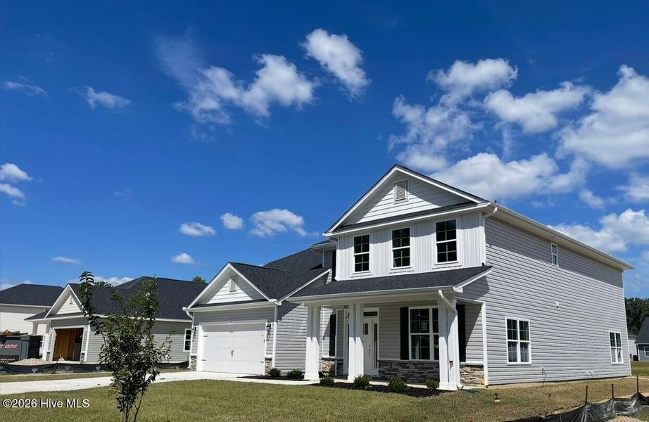 Front exterior of a new home in Summer Place, Grimesland, NC, highlighting curb appeal (Image 2). Front exterior of a new home in Summer Place, Grimesland, NC, highlighting curb appeal (Image 2).