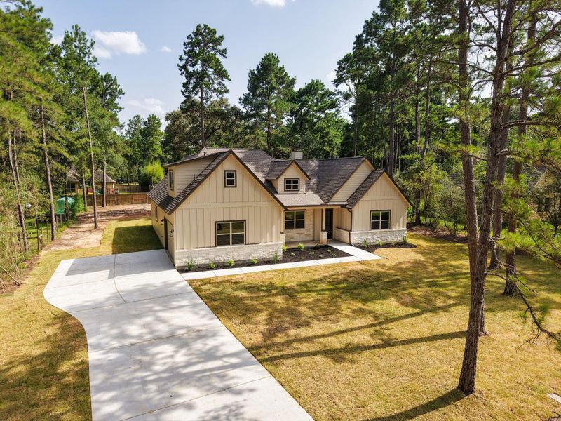 Front exterior of a new home in , Magnolia, TX, highlighting curb appeal (Image 21).