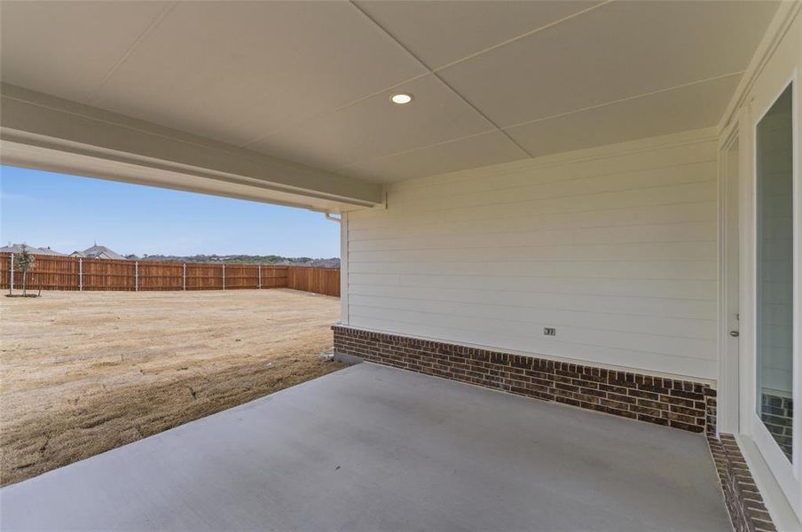 Fenced backyard with a patio area