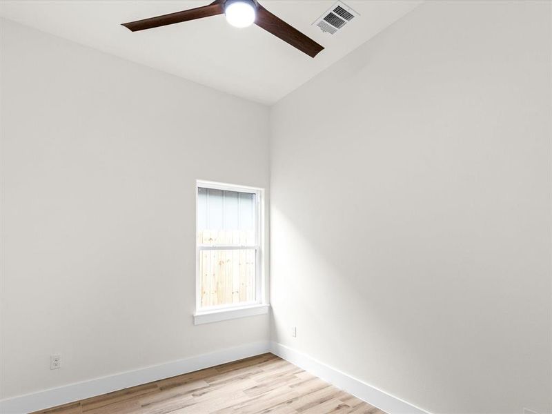 Unfurnished room with light wood finished floors and ceiling fan