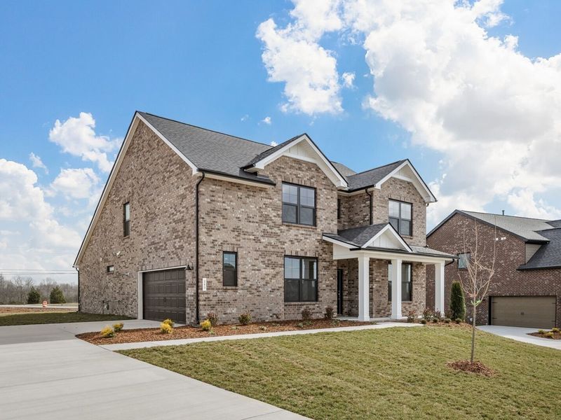 Front exterior of a new home in Benders Cove, Mount Juliet, TN, highlighting curb appeal (Image 25). Front exterior of a new home in Benders Cove, Mount Juliet, TN, highlighting curb appeal (Image 25).