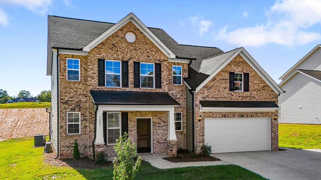 Front exterior of a new home in Brooke Hill, Lewisville, NC, highlighting curb appeal (Image 25).