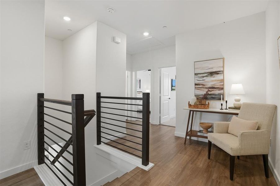 Stairs featuring wood finished floors, attic access, and recessed lighting Stairs featuring wood finished floors, attic access, and recessed lighting