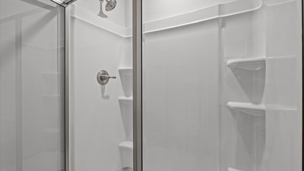 Superior en-suite primary bathroom with stylish dual vanity and walk-in shower—crafted with high standards in mind