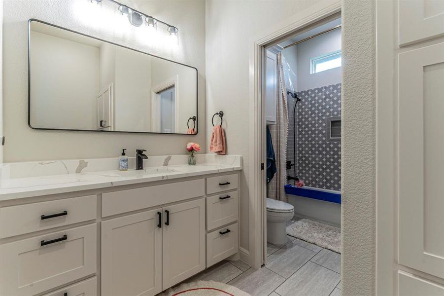 Full bathroom featuring vanity and shower / washtub combination Full bathroom featuring vanity and shower / washtub combination