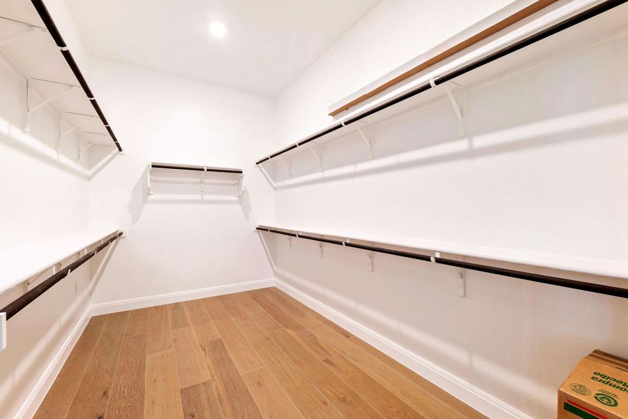 Ample shelving and hanging rods ensure an organized wardrobe in this bright, functional closet. Ample shelving and hanging rods ensure an organized wardrobe in this bright, functional closet.
