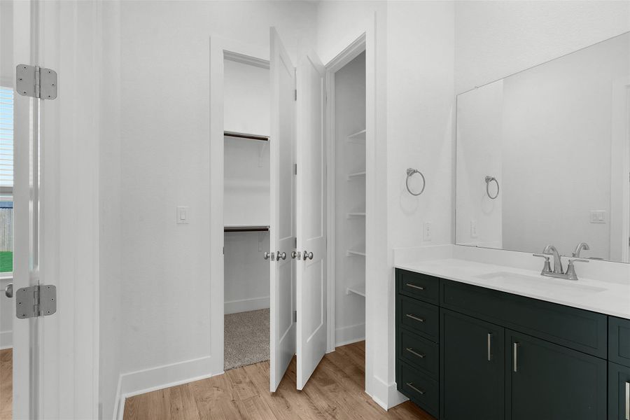 Ample storage options meet a streamlined vanity in this well-appointed bathroom.